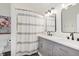 Bathroom with double vanity, shower/tub combo, and neutral decor at 7742 Bayridge Dr, Indianapolis, IN 46236