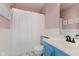 Well-lit bathroom with a blue vanity, white shower curtain, and stylish decor at 7742 Bayridge Dr, Indianapolis, IN 46236