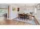 Dining area with hardwood flooring, a charming chandelier, and plenty of natural light at 7742 Bayridge Dr, Indianapolis, IN 46236