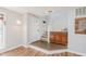 Bright foyer with hardwood floors, staircase, and a classic wooden console table at 7742 Bayridge Dr, Indianapolis, IN 46236