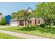 Attractive home featuring brick accents, mature trees, and a well-maintained lawn at 7742 Bayridge Dr, Indianapolis, IN 46236