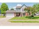 Charming two-story home featuring a brick facade, attached garage, and beautifully landscaped front yard at 7742 Bayridge Dr, Indianapolis, IN 46236