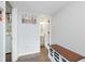 Hallway leading to bathroom features storage bench and views to another room at 7742 Bayridge Dr, Indianapolis, IN 46236