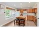 Eat-in kitchen with stainless appliances, tile flooring, and a large window at 7742 Bayridge Dr, Indianapolis, IN 46236