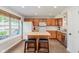 Charming kitchen features wood cabinetry, an island, and a large window at 7742 Bayridge Dr, Indianapolis, IN 46236
