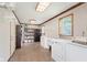 Spacious laundry room with washer, dryer, folding sink, storage and lots of shelving at 7742 Bayridge Dr, Indianapolis, IN 46236