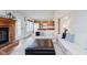 Comfortable living room with a fireplace, hardwood floors, and a view of the kitchen at 7742 Bayridge Dr, Indianapolis, IN 46236