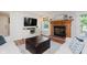 Cozy living room features a brick fireplace, hardwood floors, and ample natural light at 7742 Bayridge Dr, Indianapolis, IN 46236