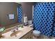 Cozy bathroom with a blue patterned shower curtain, tan vanity, and decorative accents at 8370 State Road 236, North Salem, IN 46165
