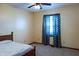 Bedroom with carpet flooring, a ceiling fan, and a window providing natural light at 8370 State Road 236, North Salem, IN 46165