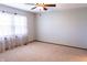 Bright bedroom featuring neutral carpet, light walls, and sheer curtains at 8370 State Road 236, North Salem, IN 46165