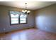 Dining room with hardwood floors, neutral walls, and a window with floral valance at 8370 State Road 236, North Salem, IN 46165