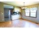Open dining room with hardwood floors, chandelier, and view into the kitchen at 8370 State Road 236, North Salem, IN 46165