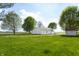 Exterior shot of a home and shed on a large lot with green grass and mature trees at 8370 State Road 236, North Salem, IN 46165