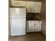 This kitchen area showcases a refrigerator, ample cabinet space, and a sleek countertop at 8370 State Road 236, North Salem, IN 46165