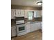 Bright kitchen featuring white cabinets, modern appliances, and a double basin sink at 8370 State Road 236, North Salem, IN 46165