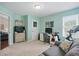 Bright bedroom featuring neutral carpet, a dedicated workspace, and a modern exercise bike at 863 Lionshead Ln, Greenwood, IN 46143