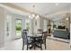 Cozy dining area with a round table and chairs, tile floor and views of the backyard at 863 Lionshead Ln, Greenwood, IN 46143
