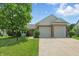 Charming home featuring a two-car garage, brick accents, well-manicured lawn, and mature trees for added curb appeal at 863 Lionshead Ln, Greenwood, IN 46143