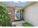 Charming entryway with brick accents, a glass front door, and attractive landscaping at 863 Lionshead Ln, Greenwood, IN 46143