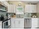 Modern kitchen with white cabinets, stainless steel appliances, and stylish backsplash at 863 Lionshead Ln, Greenwood, IN 46143