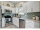 Bright kitchen featuring white cabinets, stainless steel appliances and sleek countertops at 863 Lionshead Ln, Greenwood, IN 46143