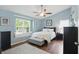 Spacious main bedroom with a window seat, ceiling fan, and light blue walls at 863 Lionshead Ln, Greenwood, IN 46143