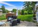 Relaxing backyard with a patio seating area, lush green lawn, and a charming grill for outdoor cooking at 907 N Arlington Ave, Indianapolis, IN 46219