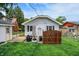 Charming backyard with a patio seating area, a fenced-in yard, and a well-maintained lawn at 907 N Arlington Ave, Indianapolis, IN 46219