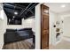 Finished basement featuring dark ceiling, gray sofa, wood flooring and TV at 907 N Arlington Ave, Indianapolis, IN 46219