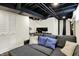 Finished basement featuring a comfortable couch and dedicated workspace with modern monitors and a desk at 907 N Arlington Ave, Indianapolis, IN 46219