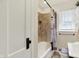 Charming bathroom with tiled shower, vintage fixtures, and a built-in storage cabinet at 907 N Arlington Ave, Indianapolis, IN 46219