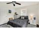 Inviting bedroom with natural light, a ceiling fan, and neutral décor for a relaxing atmosphere at 907 N Arlington Ave, Indianapolis, IN 46219