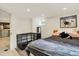Modern bedroom boasts tile floor, metal dog crate and comfy bed with large windows at 907 N Arlington Ave, Indianapolis, IN 46219