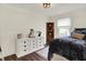 Bright bedroom with cozy decor, white dresser, and a playful stuffed husky at 907 N Arlington Ave, Indianapolis, IN 46219