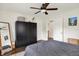 Cozy bedroom featuring ceiling fan, large closet, and views into the other rooms at 907 N Arlington Ave, Indianapolis, IN 46219