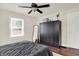 Bright bedroom with ceiling fan, ample closet space, and a dark-wood wardrobe at 907 N Arlington Ave, Indianapolis, IN 46219