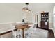 Inviting dining room with a wooden table, seating for six, and charming overhead lighting at 907 N Arlington Ave, Indianapolis, IN 46219