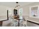 Bright dining room features hardwood floors, an elegant light fixture, and a decorative hutch at 907 N Arlington Ave, Indianapolis, IN 46219