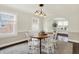 Cozy dining area featuring a round table, comfortable chairs, and natural light from nearby windows at 907 N Arlington Ave, Indianapolis, IN 46219