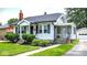 Lovely home with well-kept lawn, mature landscaping, and a quaint side porch at 907 N Arlington Ave, Indianapolis, IN 46219