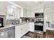 Well-lit kitchen with stainless steel appliances, granite countertops, and stylish tile backsplash at 907 N Arlington Ave, Indianapolis, IN 46219