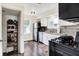 Modern kitchen with stainless steel appliances, white cabinetry, and a pantry for ample storage at 907 N Arlington Ave, Indianapolis, IN 46219