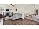 Spacious living area with a fireplace, hardwood floors, and an open layout to the dining room at 907 N Arlington Ave, Indianapolis, IN 46219