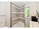 Bathroom featuring tiled shower with a window allowing natural light and neutral paint at 9080 W Forest Dr, Elwood, IN 46036