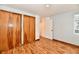 Bedroom featuring hardwood floors, neutral walls, and plenty of closet space at 9080 W Forest Dr, Elwood, IN 46036
