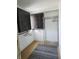 Functional closet with storage rack, upper cabinets and a modern, neutral rug at 9080 W Forest Dr, Elwood, IN 46036
