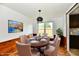 Staged dining room with a stylish table set and complementary artwork on the wall at 9080 W Forest Dr, Elwood, IN 46036