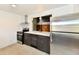 Modern kitchen with stainless steel appliances, stone countertops, and updated lighting at 9080 W Forest Dr, Elwood, IN 46036