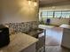 Close up on the kitchen sink and backsplash, living area in background at 9080 W Forest Dr, Elwood, IN 46036